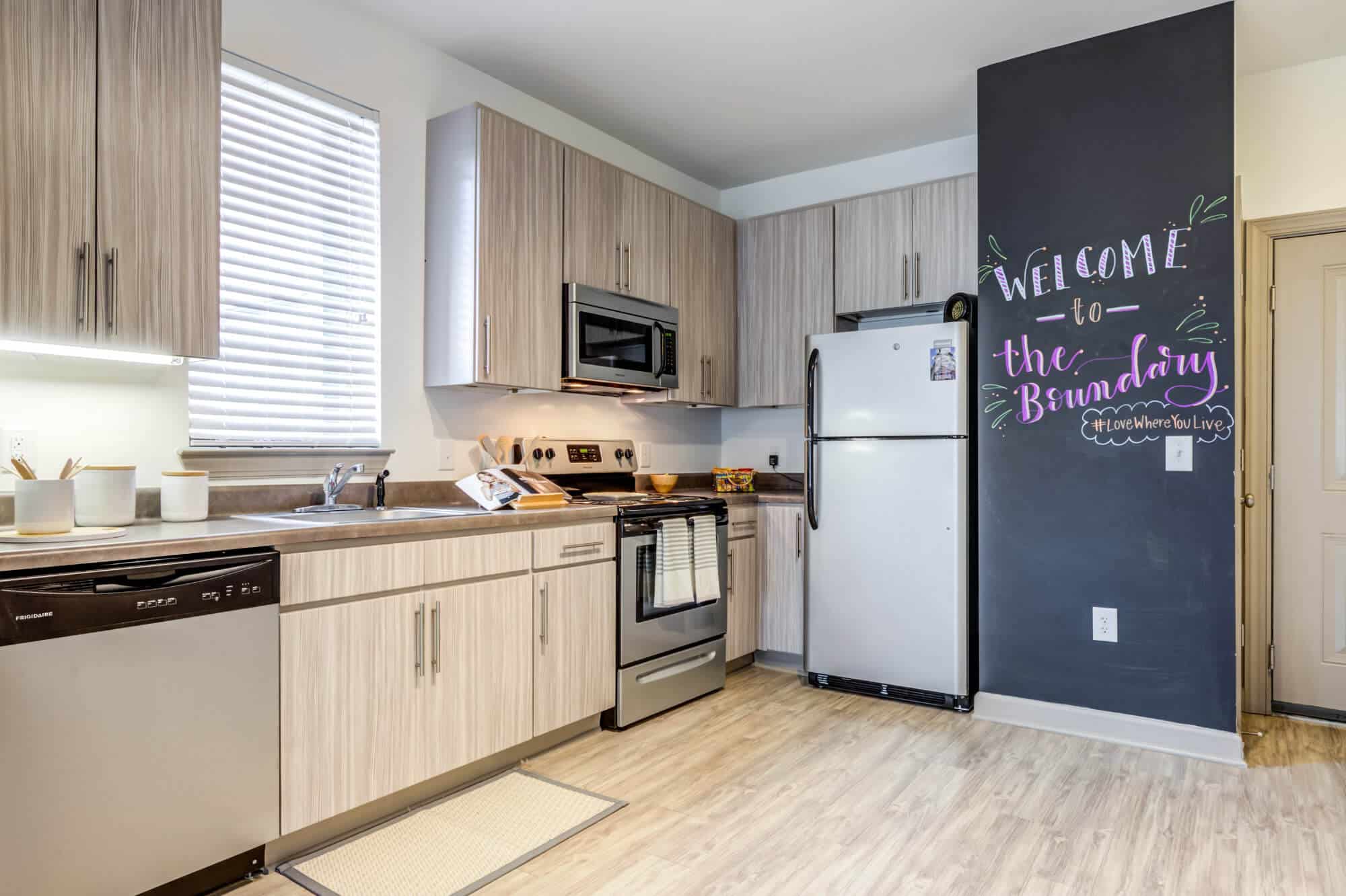 the boundary at west end off campus apartments near east carolina university ecu kitchen faux stainless steel appliances plank wood flooring